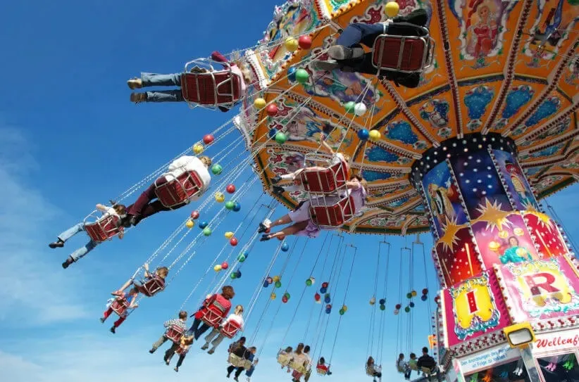 a group of people on a swing ride